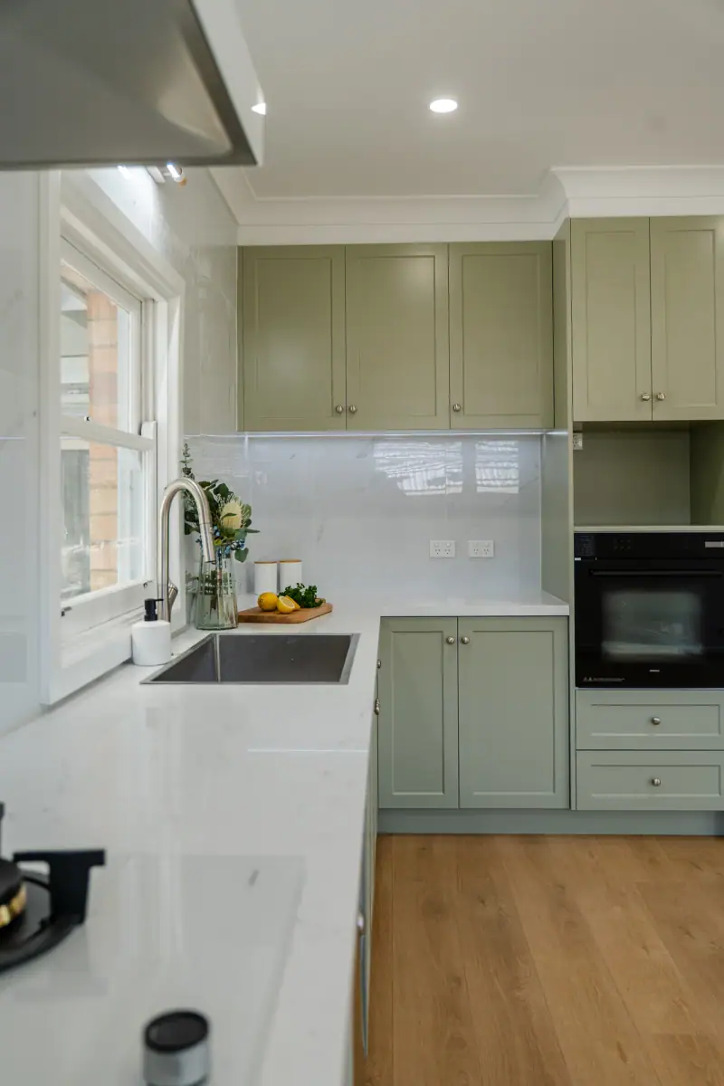 Heathmont sage green shaker kitchen with white stone benchtop