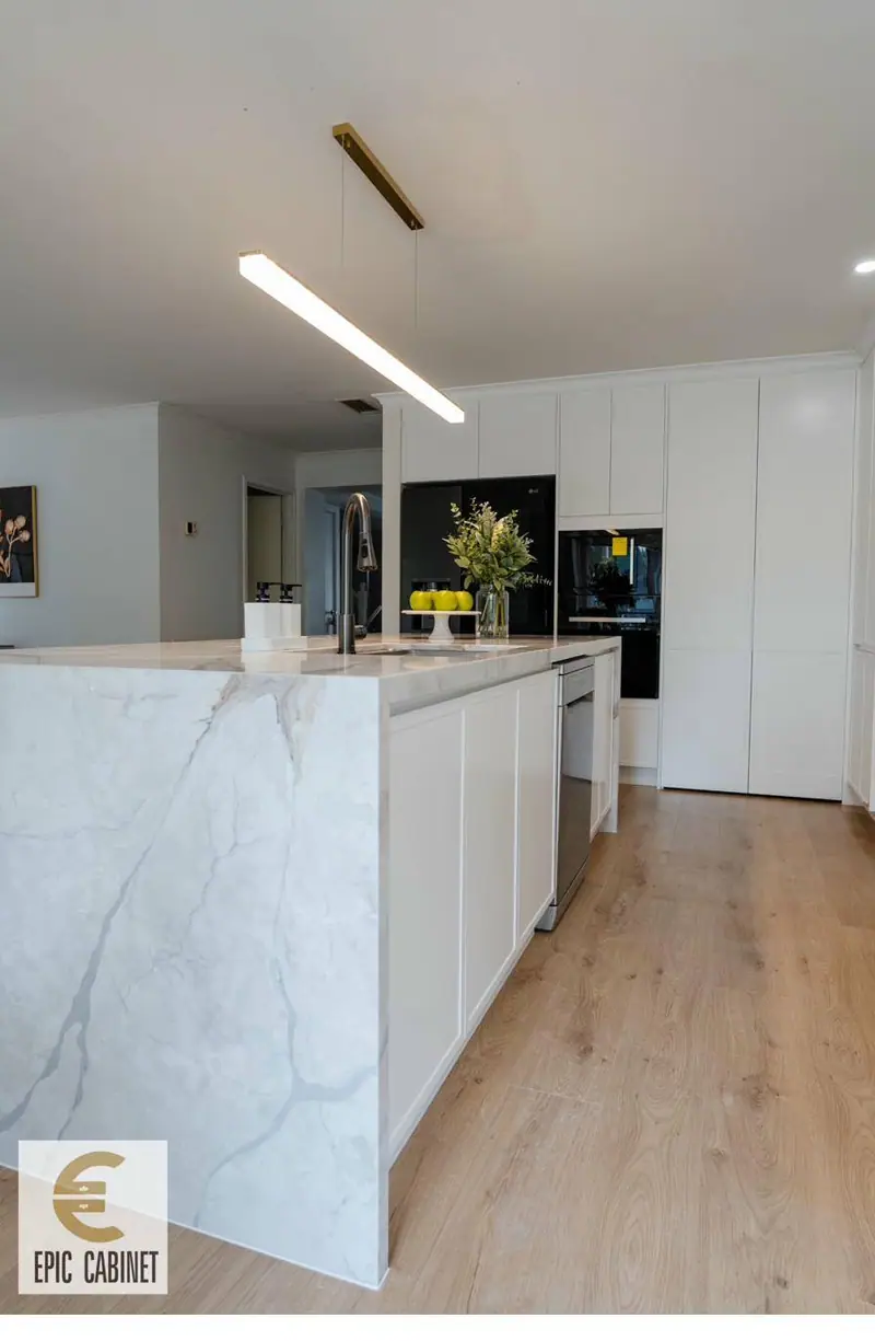 Patterson Lakes contemporary kitchen with Calacatta stone island and white flat-front cabinetry